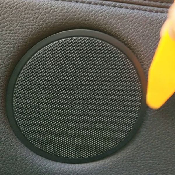 A piece of speaker grille is installed on the car door.