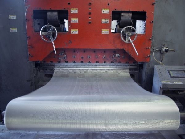A punching machine is producing micro expanded metal.